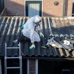 Professional Asbestos Removal Men In Protective Suits Are Remov