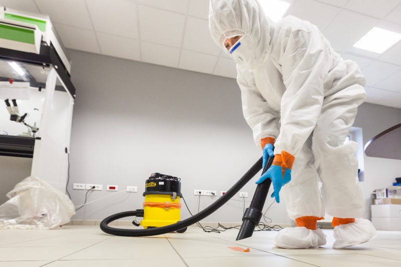 man Cleaning Asbestos For A Asbestos testing Service Partnership With Real Estate Agency 