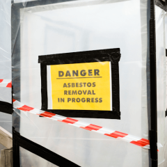 Danger asbestos removal in progress sign at a asbestos removal service Asbestos removal vs Asbestos encapsulation