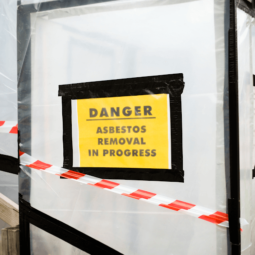 Danger asbestos removal in progress sign at a asbestos removal service.