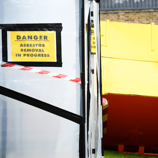 Caution asbestos removal sign at a commercial building during a asbestos removal service.